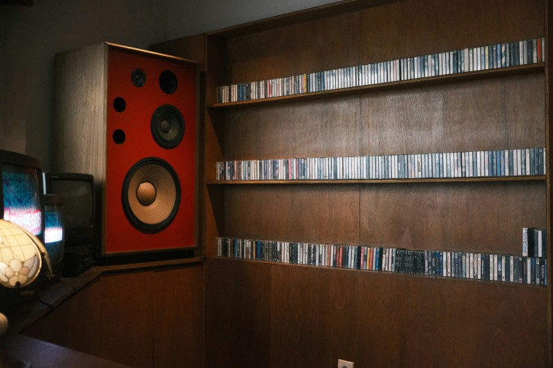 MDF speaker cabinet with large audio drivers in a home listening room