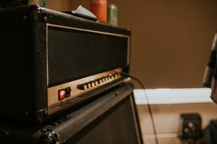 High Bass Speaker Box amplifier and speaker cabinet in a music recording studio with connected cables and control knobs