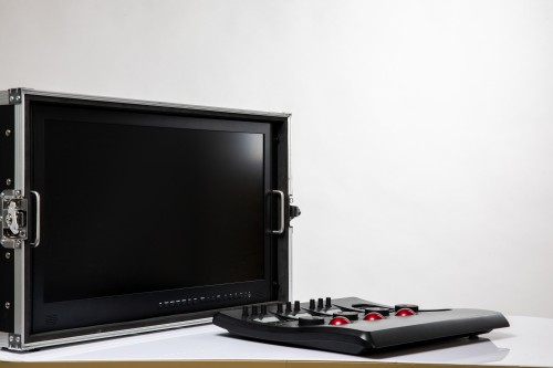 Speaker Cabinet Manufacturer showcasing a professional black display monitor housed in a rugged protective flight case alongside a control panel